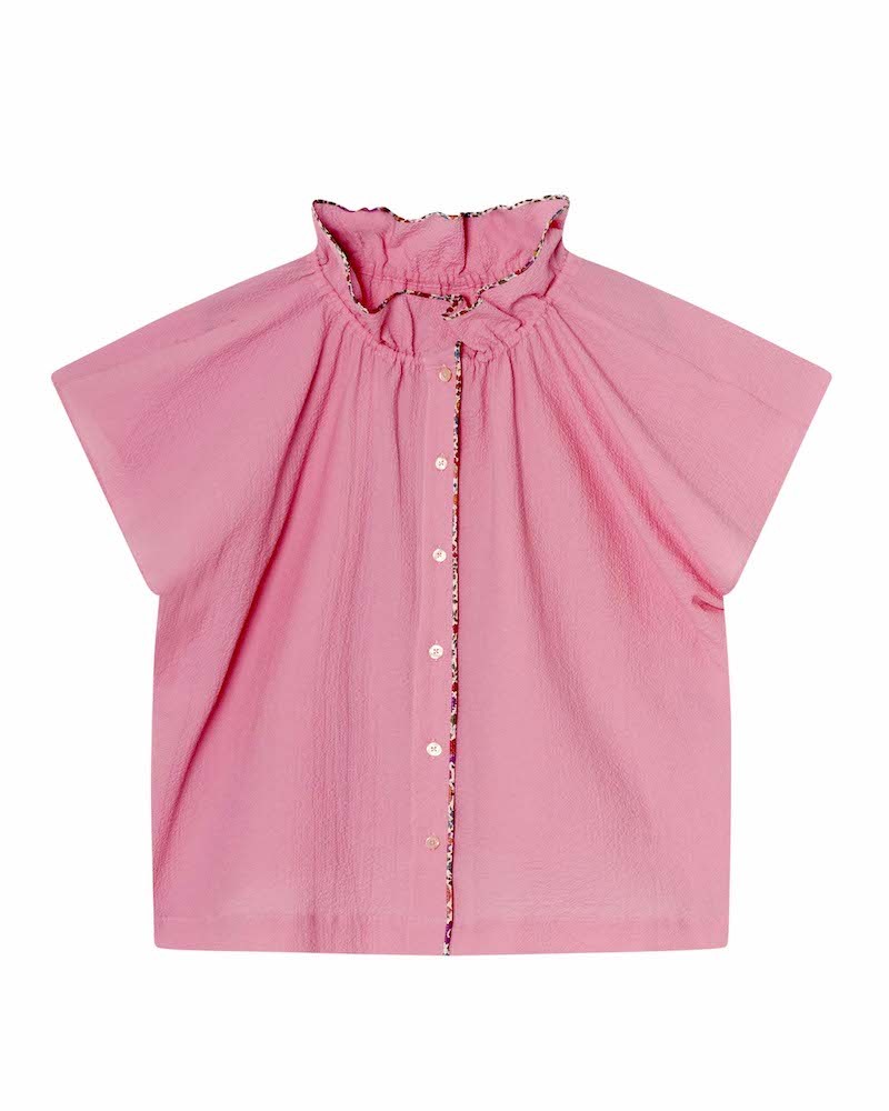 Pack shot af Apof Ada Top Flamingo pink med D'Anjo liberty piping på hvid baggrund